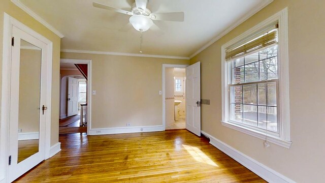 188 Upper Delevan Ave, Corning-City, NY 14830 - empty room with arched walkways, light wood-style flooring, healthy amount of natural light, a ceiling fan, and crown molding