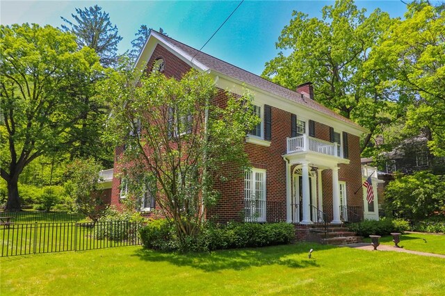 188 Upper Delevan Ave, Corning-City, NY 14830 - view of front of home with a balcony, a chimney, and brick siding