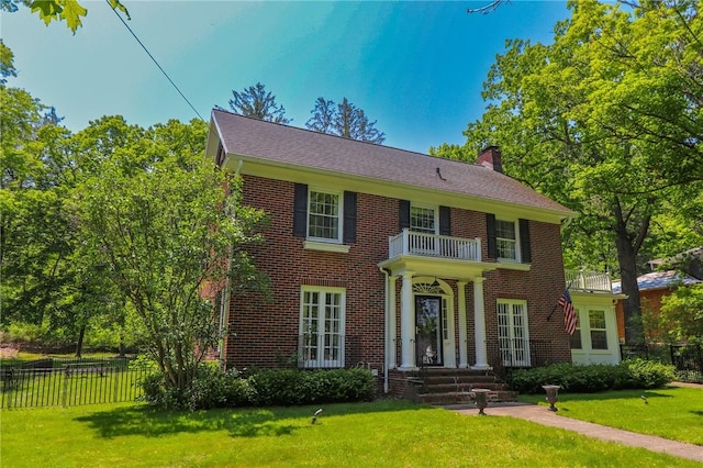 188 Upper Delevan Ave, Corning-City, NY 14830 - georgian-style home featuring a balcony, a chimney, and brick siding