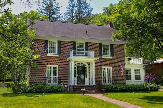188 Upper Delevan Ave, Corning-City, NY 14830 - georgian-style home with a balcony, a chimney, and brick siding