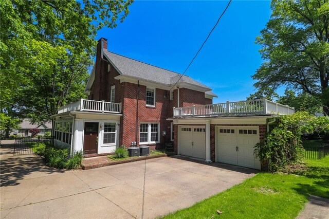 188 Upper Delevan Ave, Corning-City, NY 14830 - view of front of property featuring a balcony, brick siding, a chimney, an attached garage, and driveway
