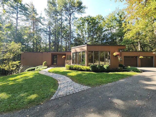 view of front of house with a garage and a front yard