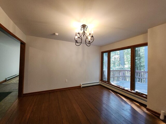 unfurnished room with dark hardwood / wood-style floors, a baseboard heating unit, and an inviting chandelier