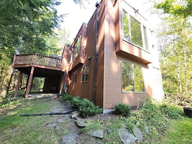 view of side of home with a wooden deck