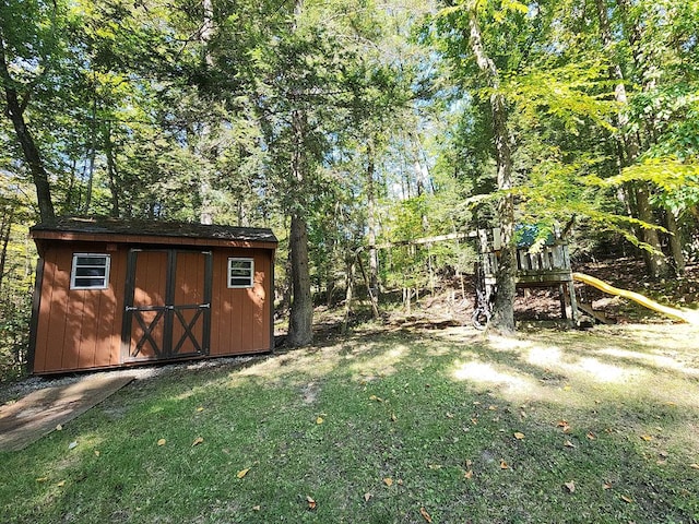 view of yard with a playground and a storage unit