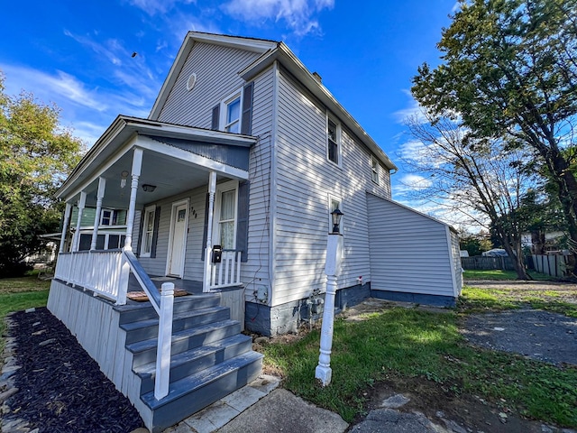 view of side of home with a porch