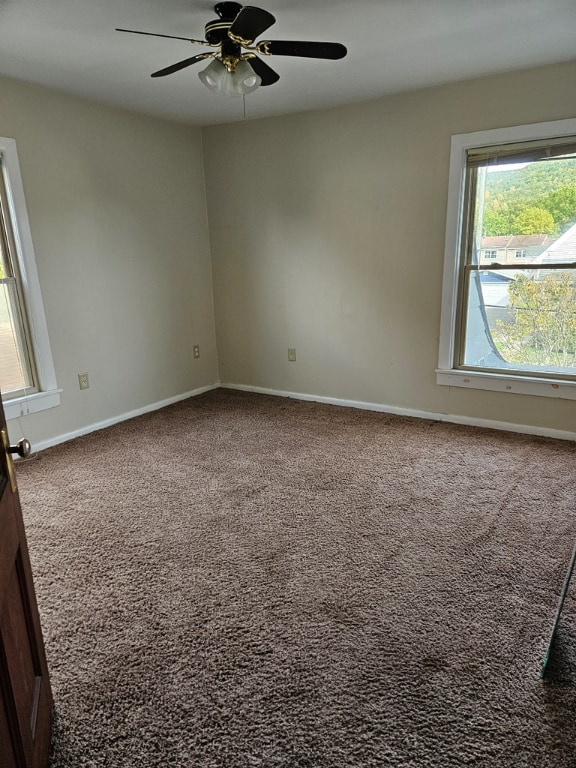 spare room featuring carpet flooring and ceiling fan