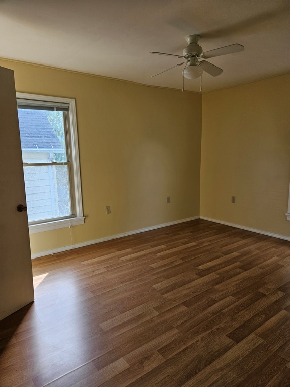 unfurnished room featuring ceiling fan and dark hardwood / wood-style flooring