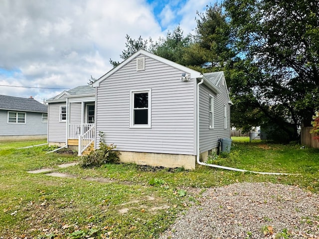 view of property exterior with a yard