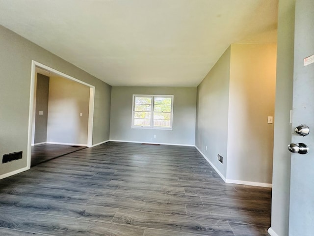 spare room featuring dark hardwood / wood-style flooring