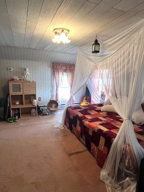 carpeted bedroom with wood ceiling