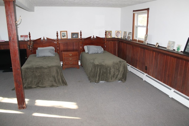 unfurnished bedroom featuring light carpet, a baseboard radiator, and a textured ceiling