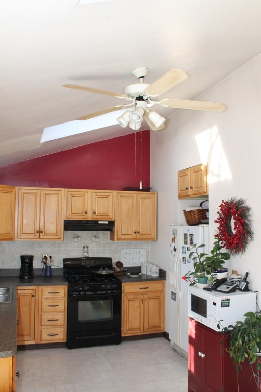 kitchen with ceiling fan, vaulted ceiling, backsplash, and white appliances