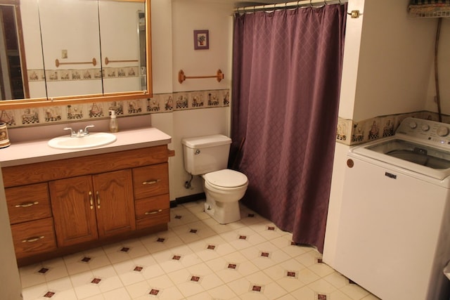 bathroom with washer / clothes dryer, vanity, and toilet