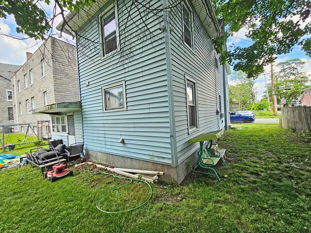 view of side of home with a lawn