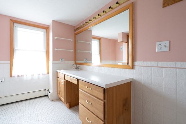 bathroom featuring vanity, tile walls, and a baseboard heating unit