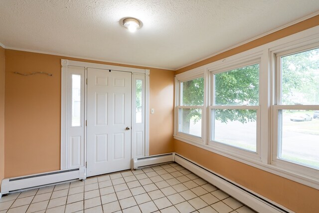 foyer entrance featuring a baseboard heating unit, a textured ceiling, and light tile patterned flooring