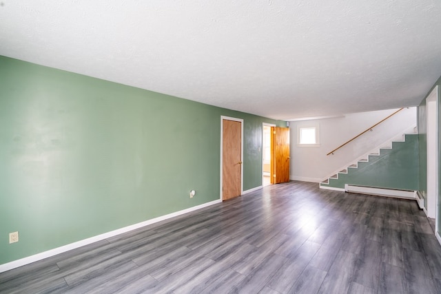 unfurnished room featuring dark hardwood / wood-style flooring, a textured ceiling, and baseboard heating