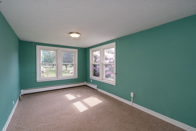 empty room featuring a baseboard radiator, carpet, and a textured ceiling