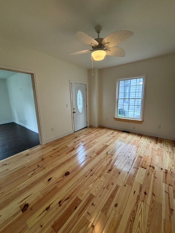 foyer with ceiling fan and light hardwood / wood-style floors