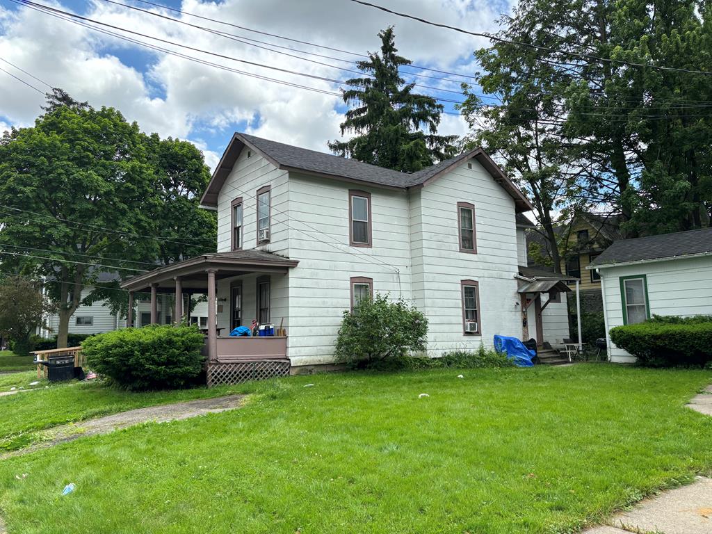 view of front of house with a porch and a front yard