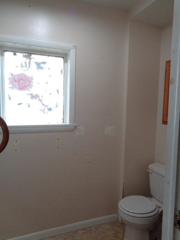 bathroom with tile patterned flooring and toilet