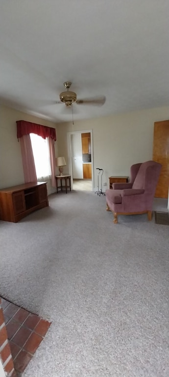 living room featuring ceiling fan and carpet