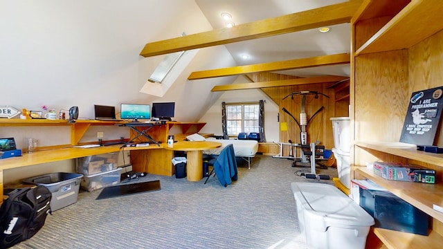 interior space featuring wooden walls, lofted ceiling with skylight, and carpet