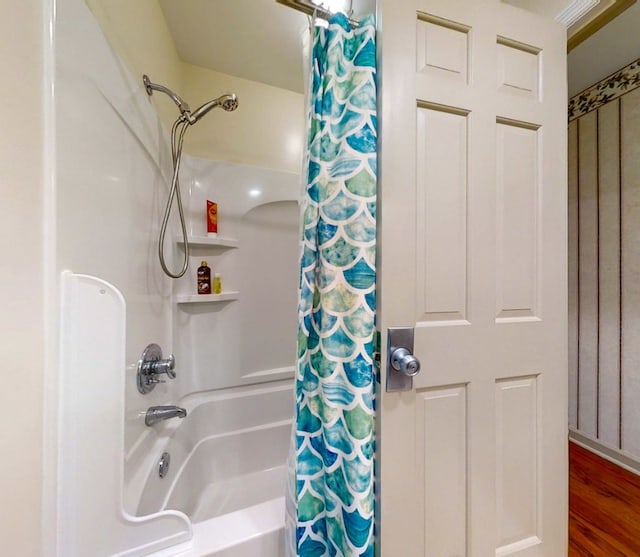 bathroom featuring shower / bathtub combination with curtain and hardwood / wood-style floors