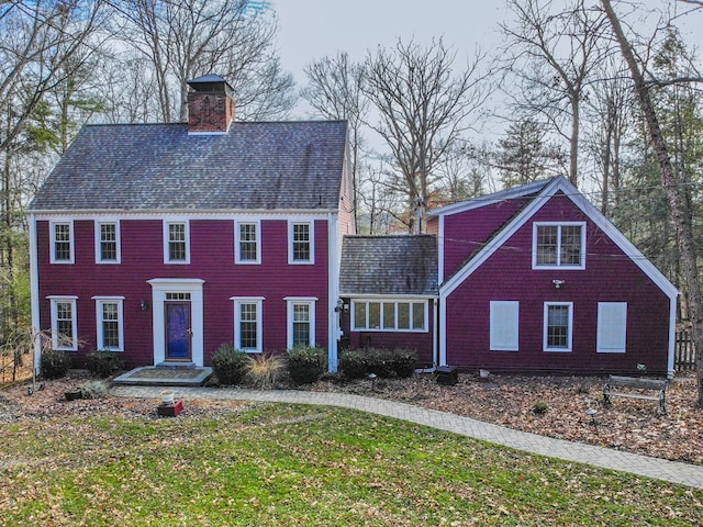 colonial-style house with a front yard