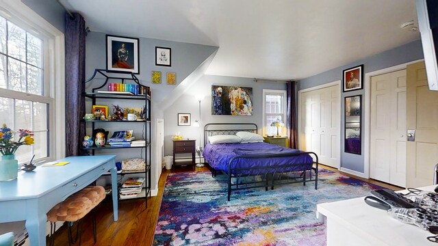 bedroom with dark wood-type flooring and a closet