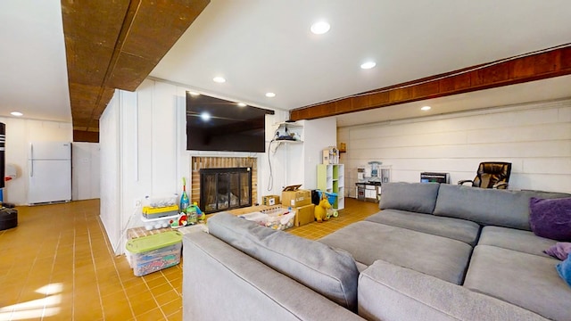 living room with a fireplace and beamed ceiling