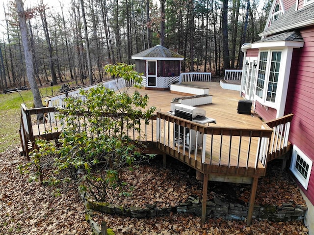 wooden terrace featuring a gazebo, a sunroom, and central air condition unit