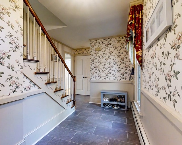 staircase featuring a baseboard heating unit