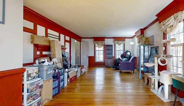 miscellaneous room featuring wood-type flooring and ornamental molding