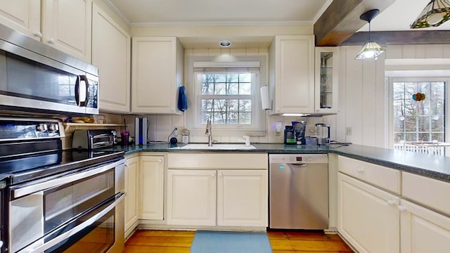 kitchen featuring white cabinetry, stainless steel appliances, and sink