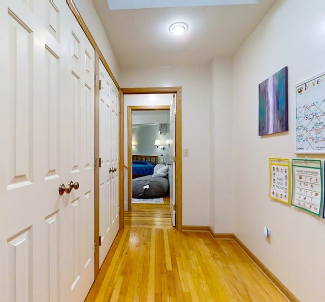 corridor with light hardwood / wood-style floors