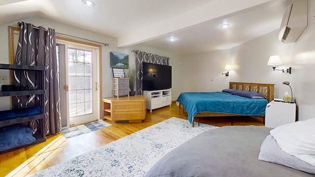 bedroom featuring beamed ceiling and light hardwood / wood-style floors