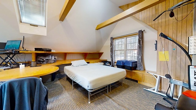 bedroom featuring wooden walls, carpet floors, and vaulted ceiling with beams