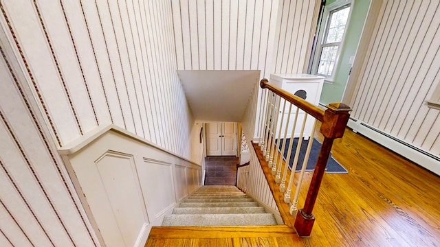 stairs featuring hardwood / wood-style flooring