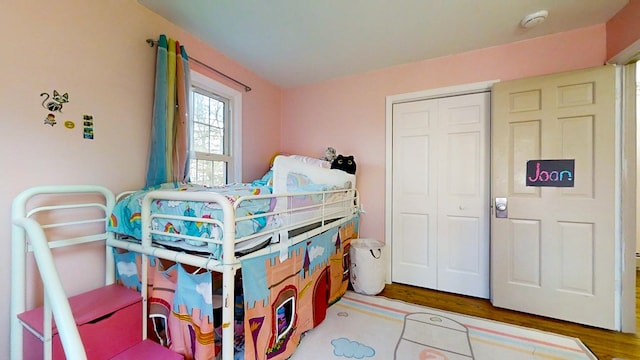 bedroom with hardwood / wood-style flooring and a closet