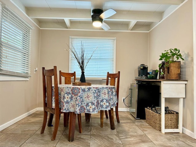 dining room featuring ceiling fan and beam ceiling