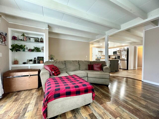 living room featuring dark wood-type flooring and beam ceiling