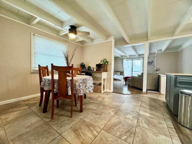 dining space featuring ceiling fan and beam ceiling