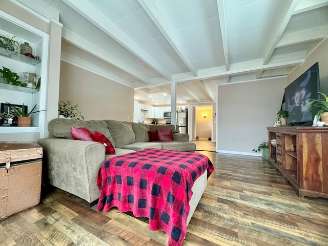 interior space with hardwood / wood-style flooring, refrigerator, and vaulted ceiling with beams