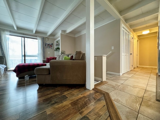 living room featuring light wood-type flooring and lofted ceiling with beams