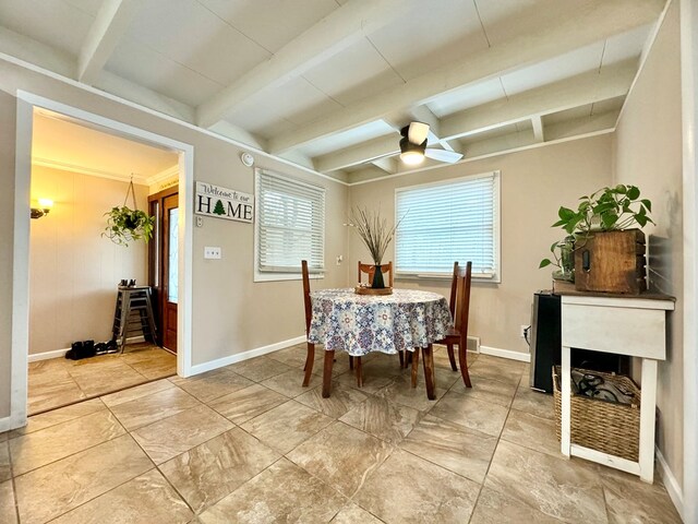 dining room with beamed ceiling and ceiling fan