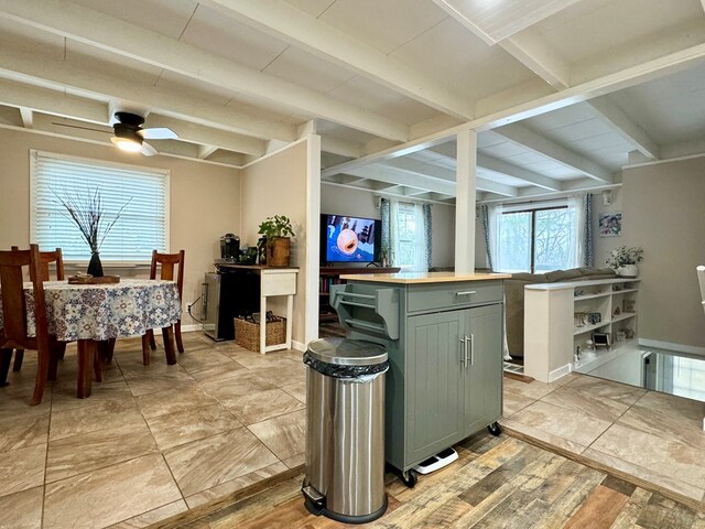 kitchen featuring beamed ceiling, ceiling fan, and green cabinetry