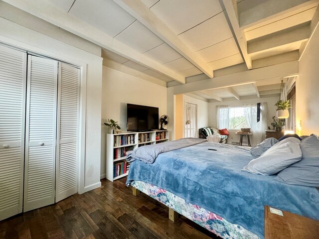 bedroom with beamed ceiling, dark hardwood / wood-style floors, and a closet