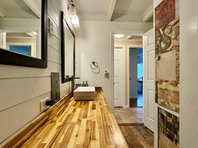 hallway with light hardwood / wood-style floors and sink